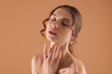 Photo of Portrait of beautiful young woman on beige background
