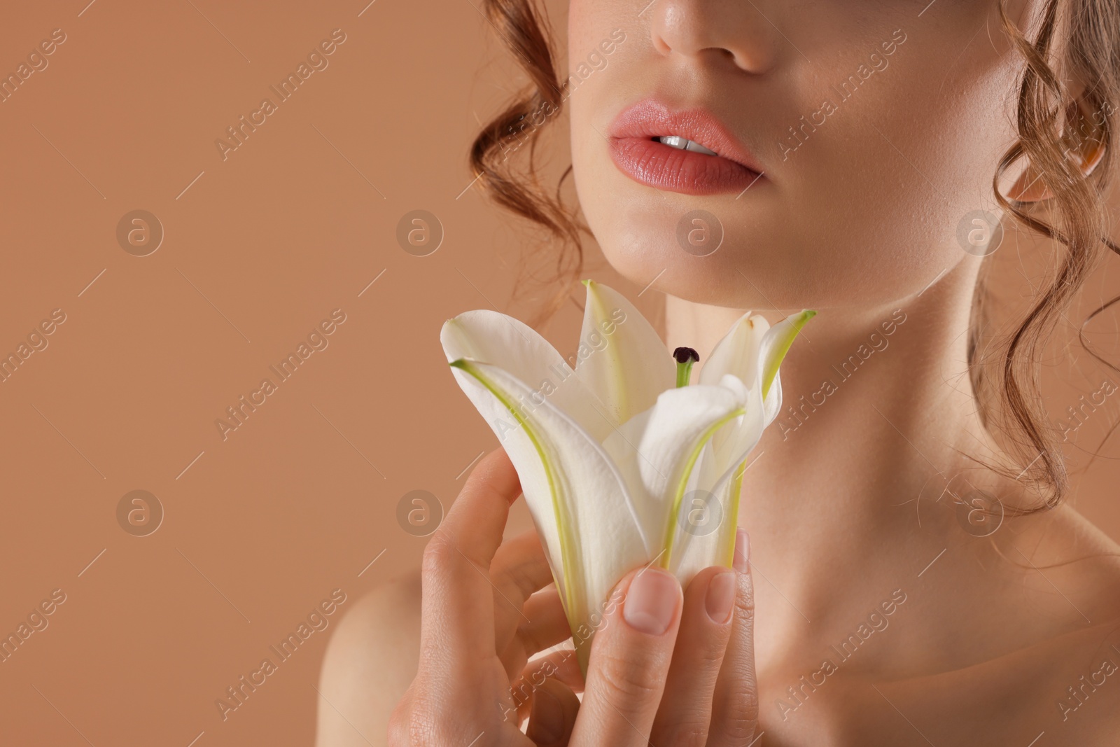 Beautiful woman with flower on beige background, closeup. Space for text Photo of Beautiful woman with flower on beige background, closeup. Space for text