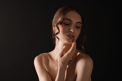 Photo of Portrait of gorgeous young woman on black background