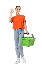 Photo of Woman with plastic shopping basket showing okay gesture on white background