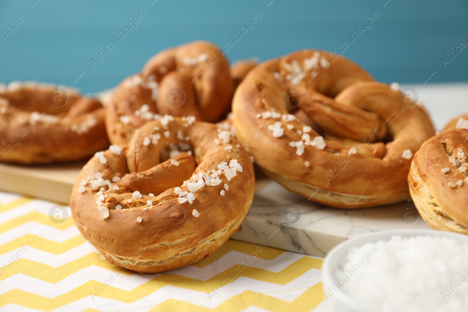 Tasty pretzels with salt on table, closeup Photo of Tasty pretzels with salt on table, closeup