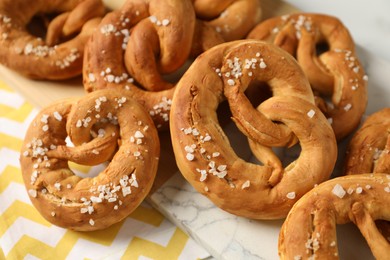 Photo of Tasty pretzels with salt on table, above view