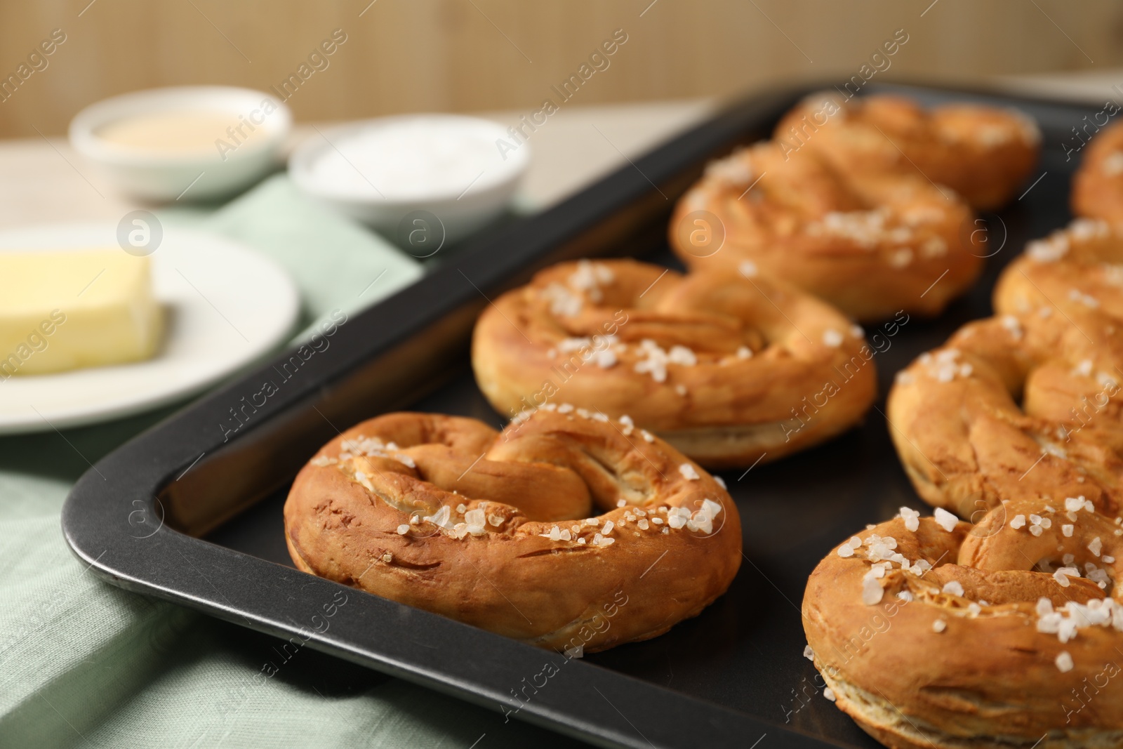 Tasty pretzels and ingredients on table, closeup Photo of Tasty pretzels and ingredients on table, closeup