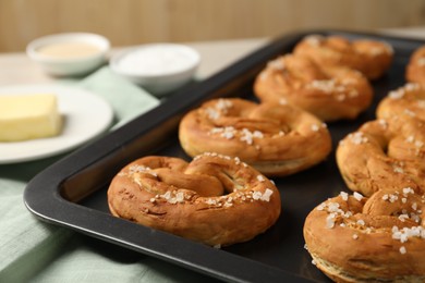 Photo of Tasty pretzels and ingredients on table, closeup