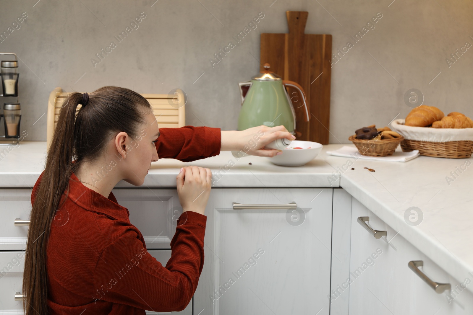 Woman spraying insecticide onto cockroaches in kitchen Photo of Woman spraying insecticide onto cockroaches in kitchen