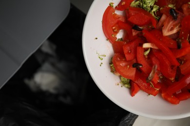Photo of Cockroaches and vegetables in bowl near trash bin, top view