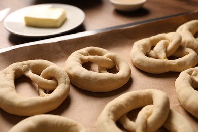 Photo of Uncooked pretzels and ingredients on table, closeup