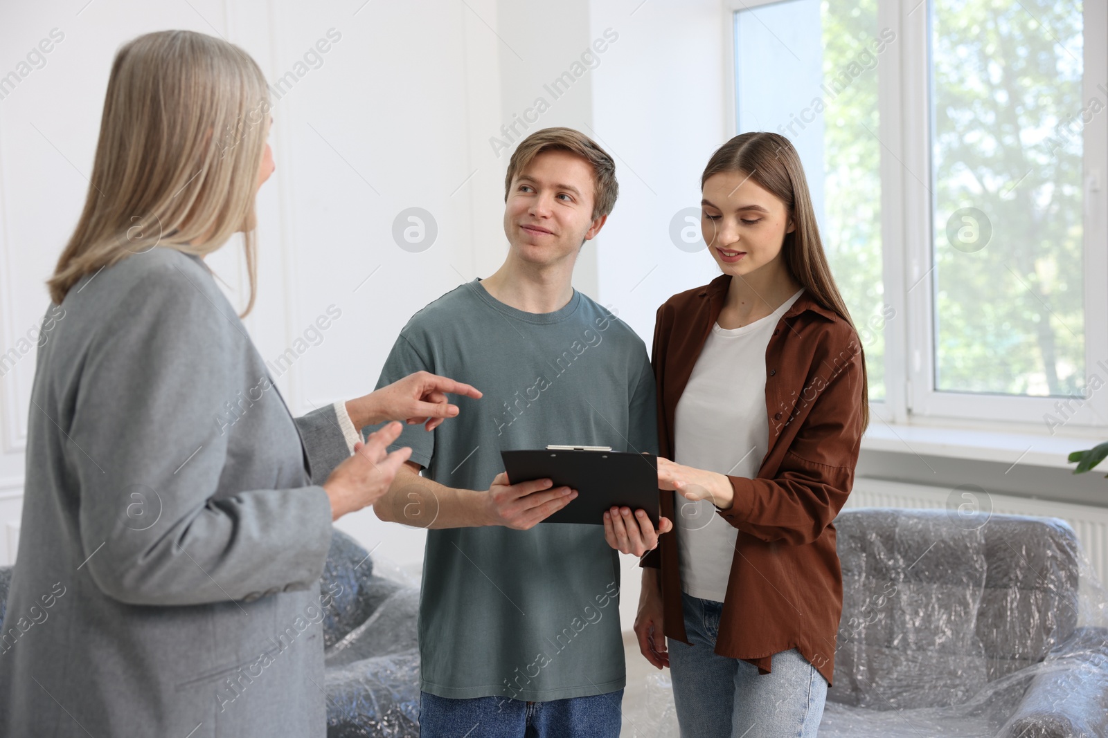 Real estate agent working with couple at home Photo of Real estate agent working with couple at home