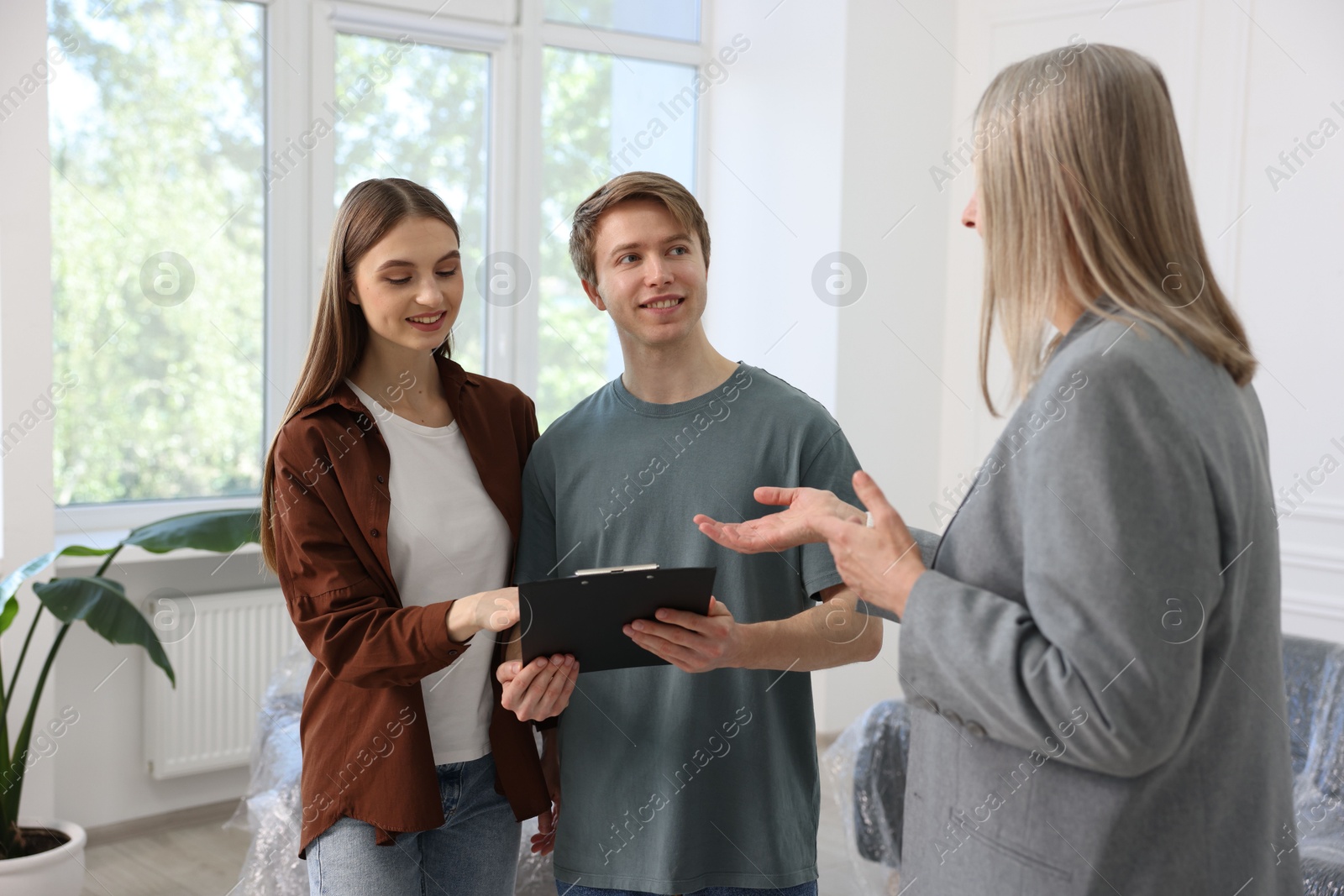 Real estate agent working with couple at home Photo of Real estate agent working with couple at home