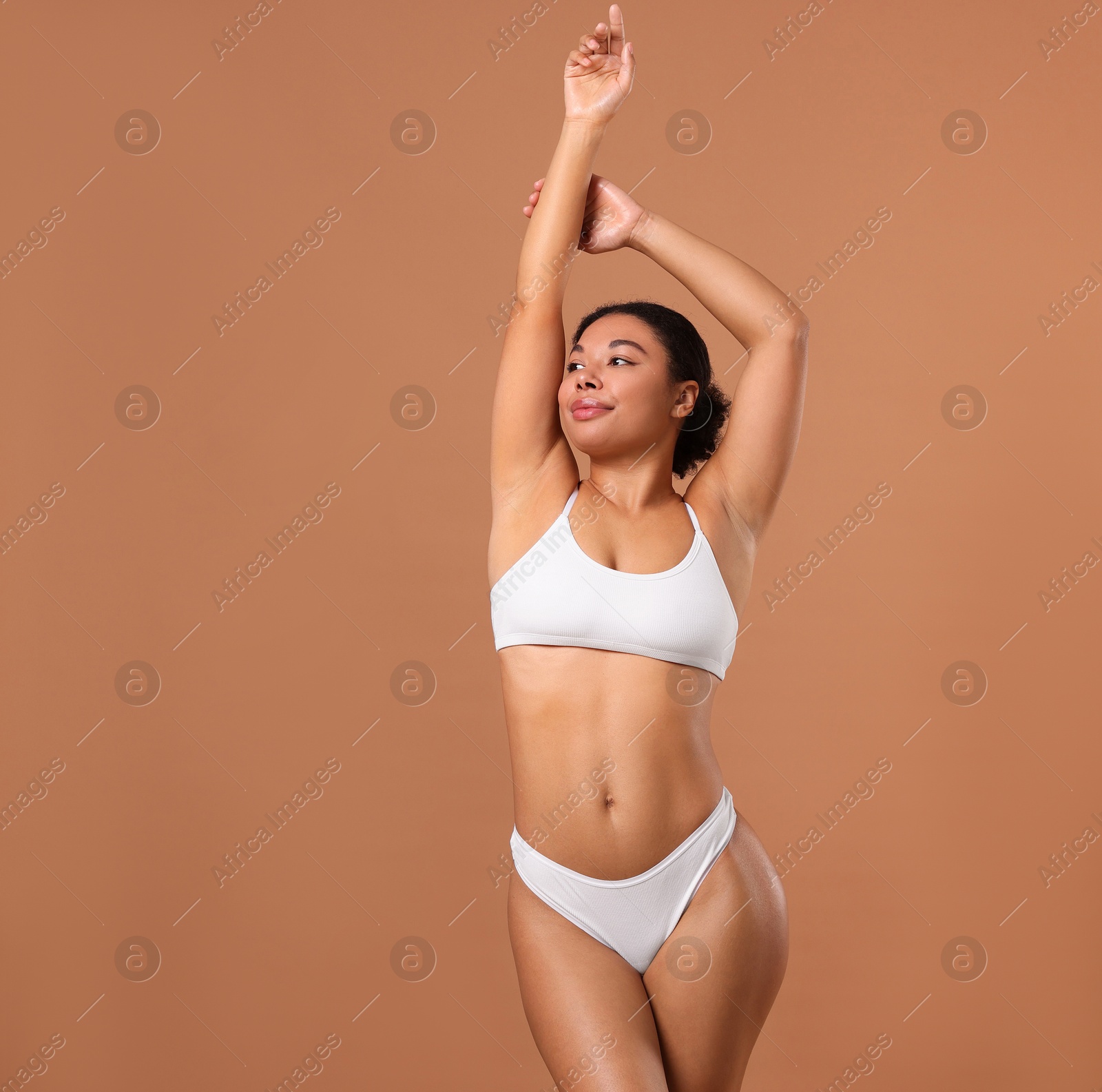 Woman in white underwear with smooth skin after epilation procedure on beige background, space for text Photo of Woman in white underwear with smooth skin after epilation procedure on beige background, space for text