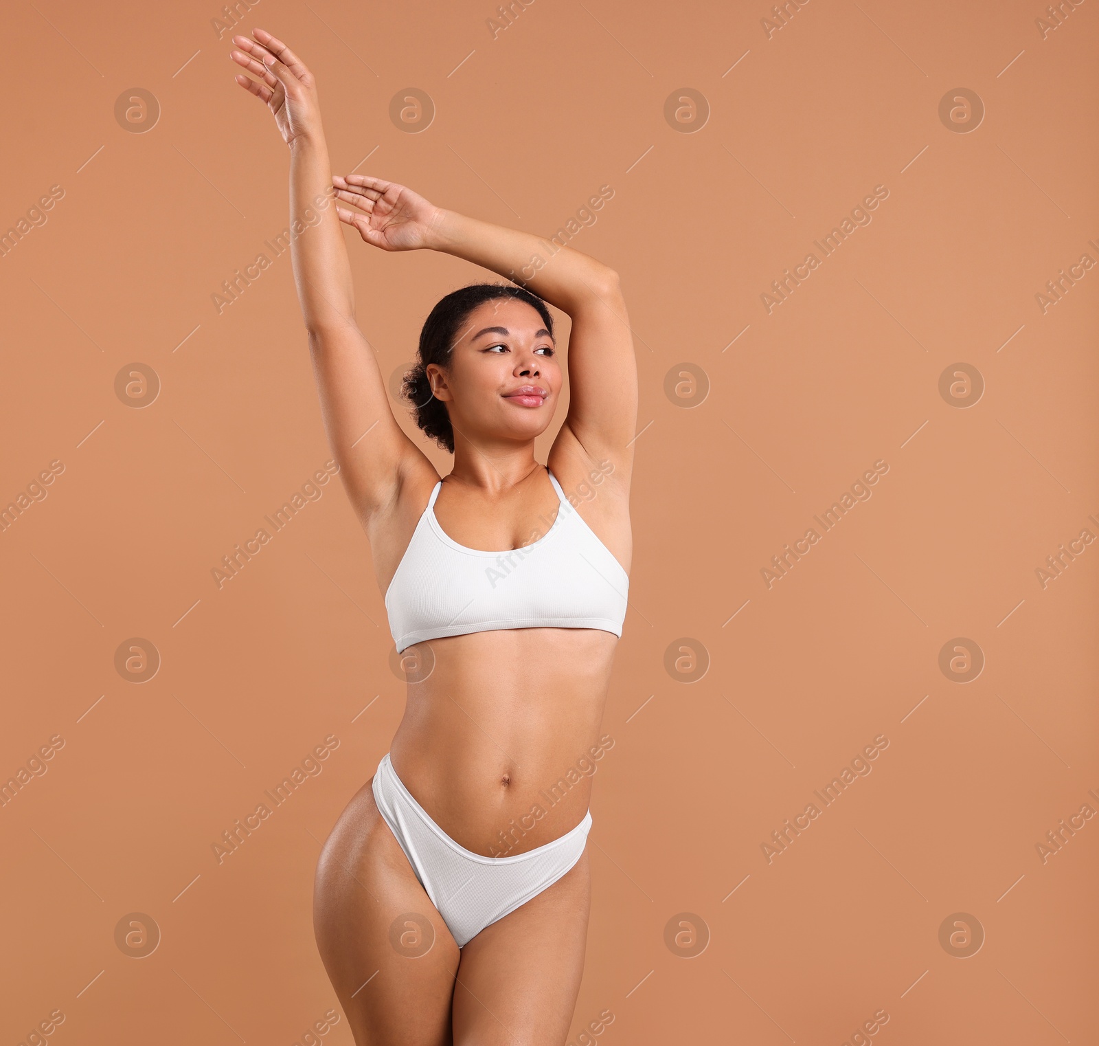Woman in white underwear with smooth skin after epilation procedure on beige background, space for text Photo of Woman in white underwear with smooth skin after epilation procedure on beige background, space for text