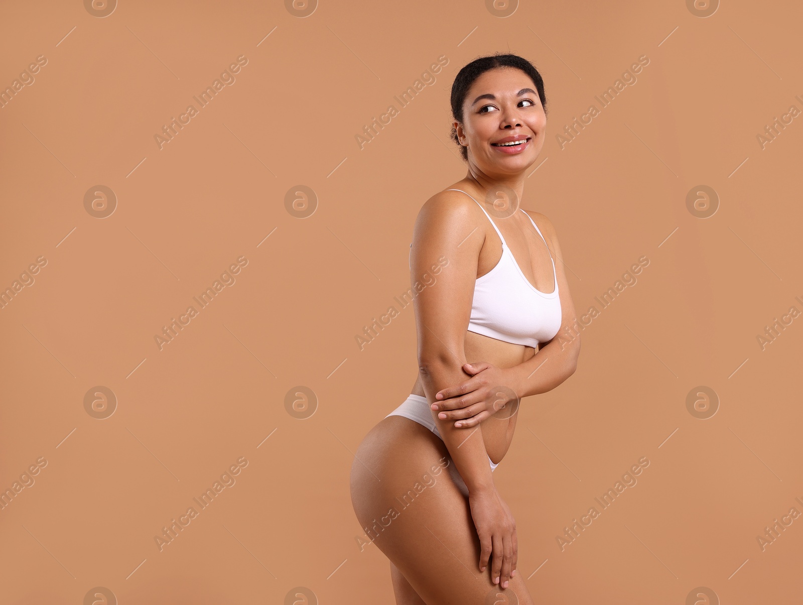 Woman in white underwear with smooth skin after epilation procedure on beige background, space for text Photo of Woman in white underwear with smooth skin after epilation procedure on beige background, space for text