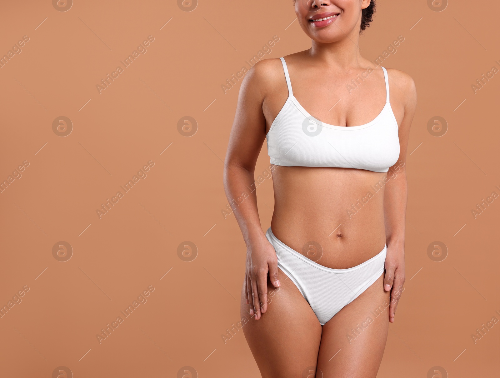 Woman in white underwear with smooth skin after epilation procedure on beige background, closeup. Space for text Photo of Woman in white underwear with smooth skin after epilation procedure on beige background, closeup. Space for text
