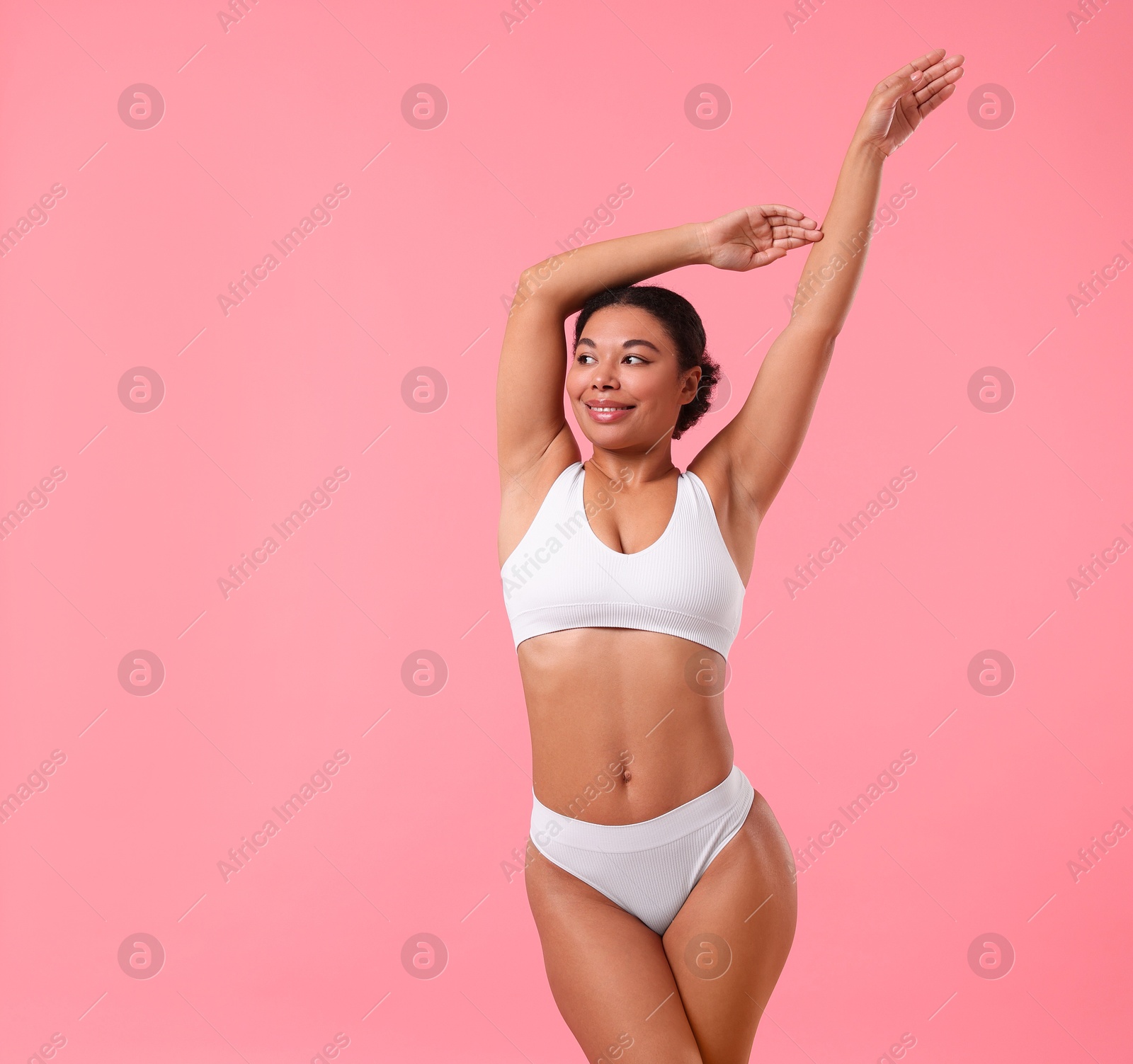 Woman in underwear with smooth skin after epilation procedure on pink background, space for text Photo of Woman in underwear with smooth skin after epilation procedure on pink background, space for text