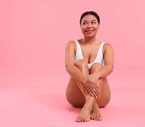 Photo of Woman in underwear with smooth skin after epilation procedure on pink background, space for text