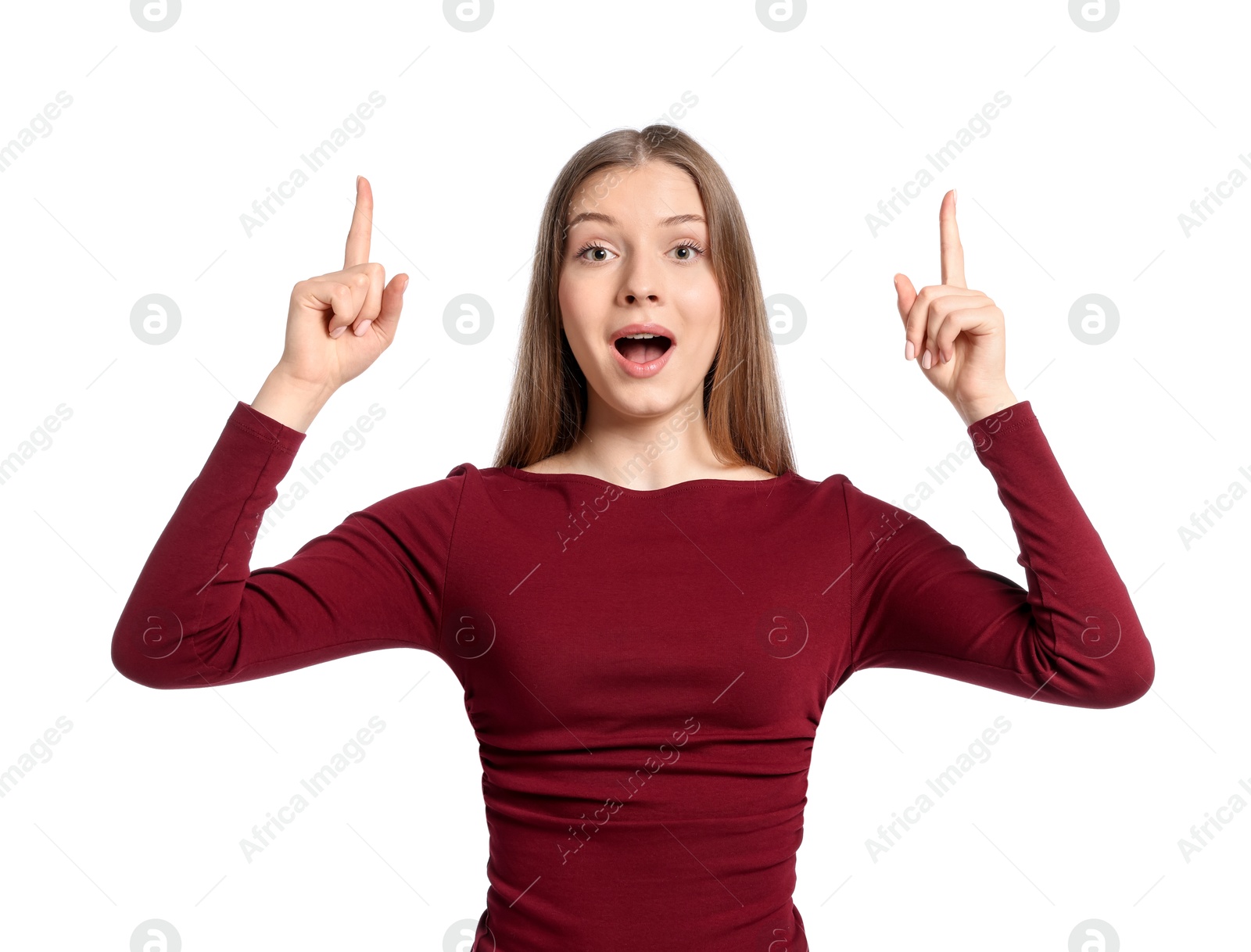 Excited teenage girl pointing at something on white background Photo of Excited teenage girl pointing at something on white background