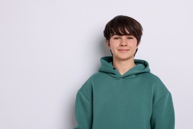 Photo of Portrait of teenage boy on white background, space for text