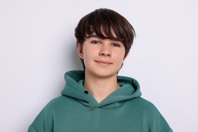 Photo of Portrait of teenage boy on white background