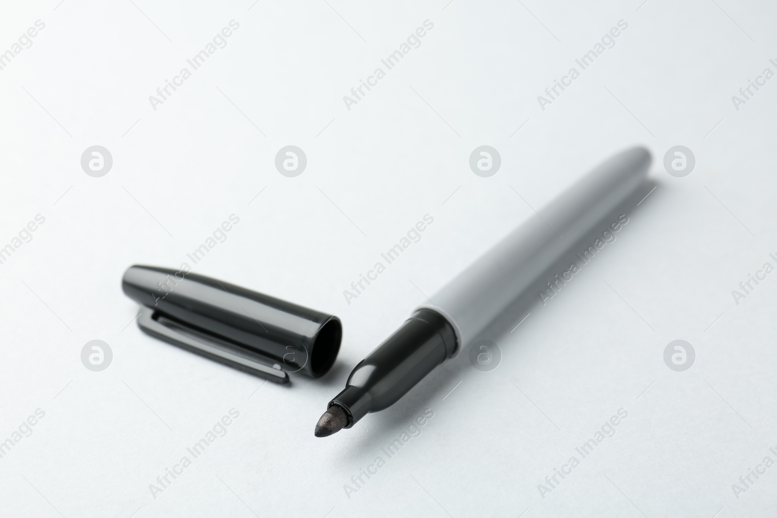 One black marker on light background, closeup. Space for text Photo of One black marker on light background, closeup. Space for text