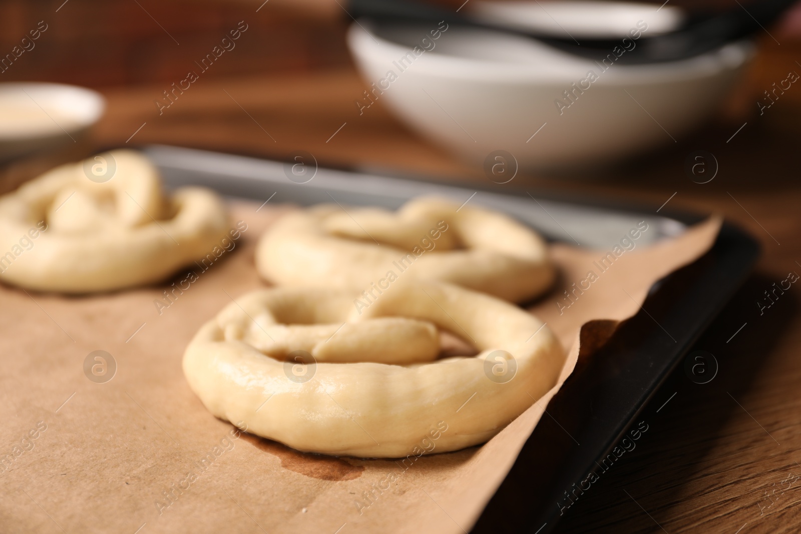 Uncooked pretzels on wooden table, closeup view Photo of Uncooked pretzels on wooden table, closeup view
