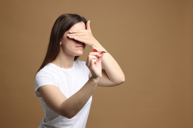 Photo of Targeting. Businesswoman with dart covering eyes on beige background. Space for text