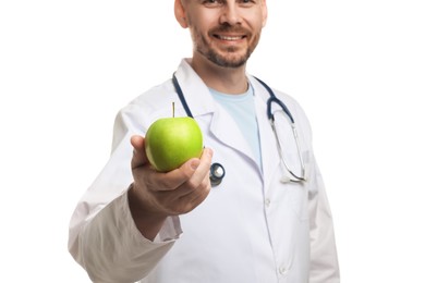 Photo of Nutritionist with green apple and stethoscope on white background, closeup