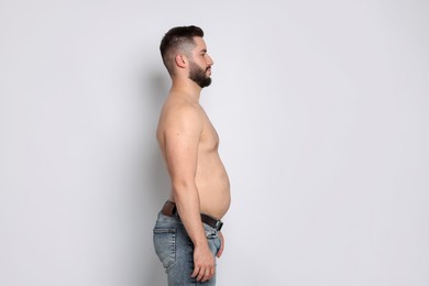 Photo of Man before weight loss on light background