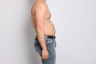 Photo of Man before weight loss on light background, closeup