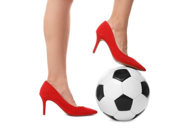 Photo of Woman in high heeled shoes with soccer ball on white background, closeup