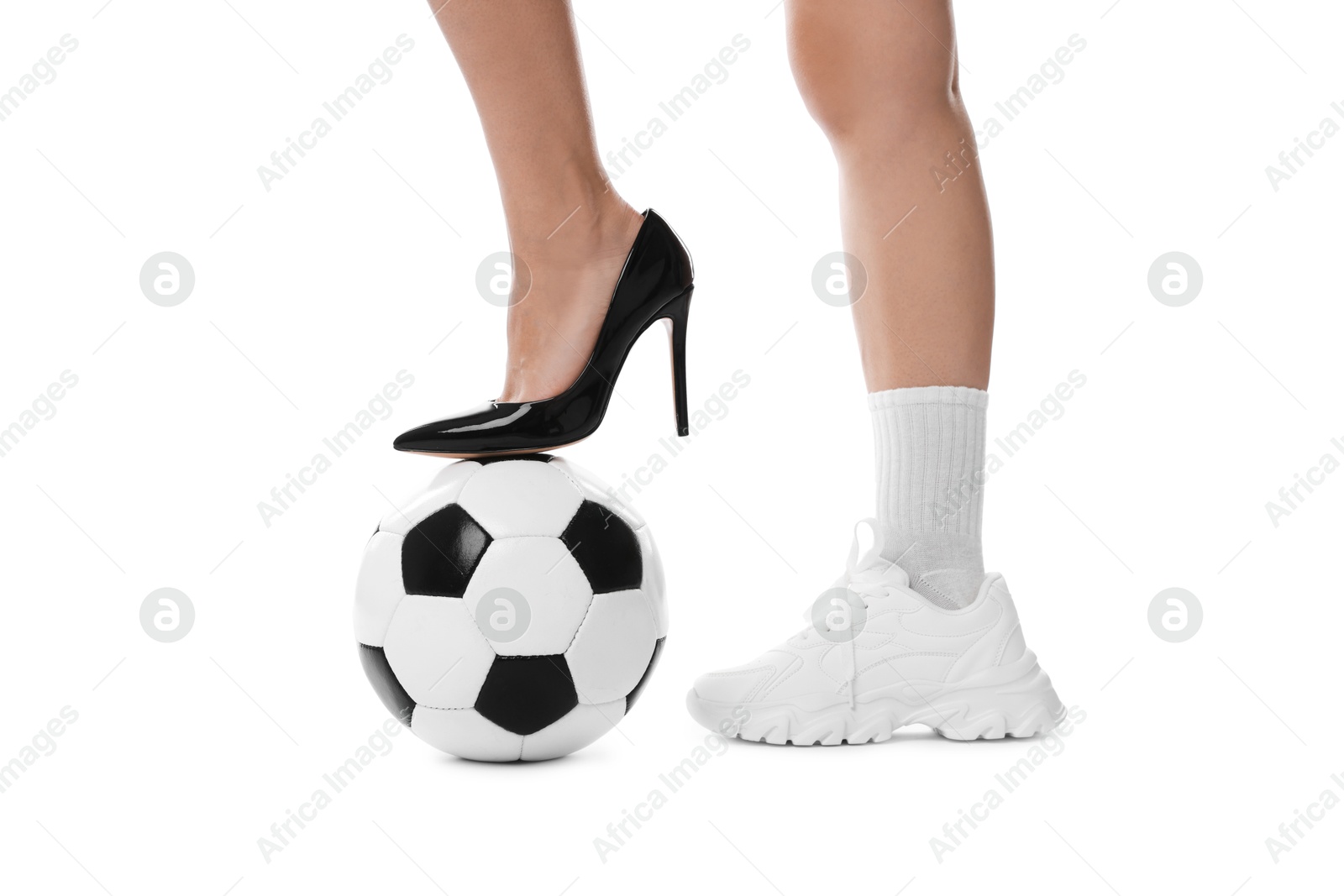 Photo of Woman in high heeled shoe and sneaker with soccer ball on white background, closeup