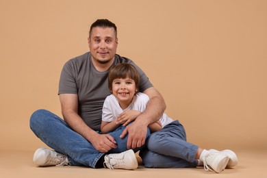 Photo of Father and his son on beige background