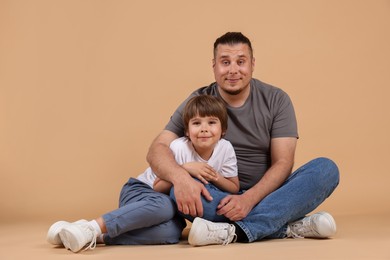 Photo of Father and his son on beige background