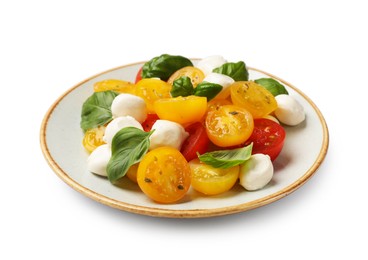 Photo of Fresh salad with yellow tomatoes, basil and mozzarella cheese isolated on white