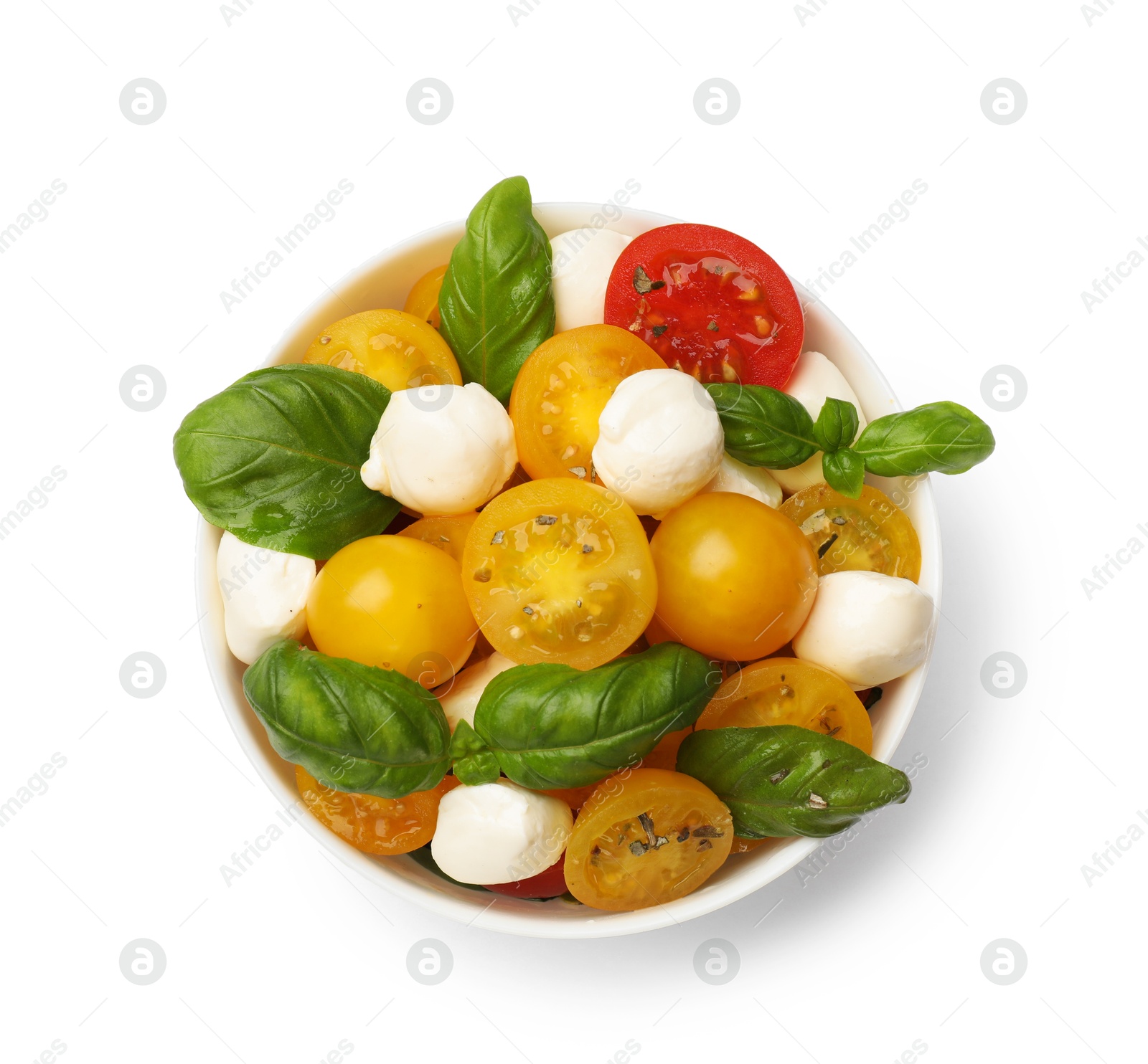 Fresh salad with yellow tomatoes, basil and mozzarella cheese in bowl isolated on white, top view Photo of Fresh salad with yellow tomatoes, basil and mozzarella cheese in bowl isolated on white, top view