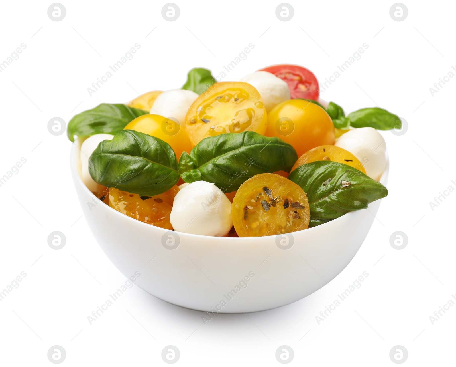 Fresh salad with yellow tomatoes, basil and mozzarella cheese in bowl isolated on white Photo of Fresh salad with yellow tomatoes, basil and mozzarella cheese in bowl isolated on white