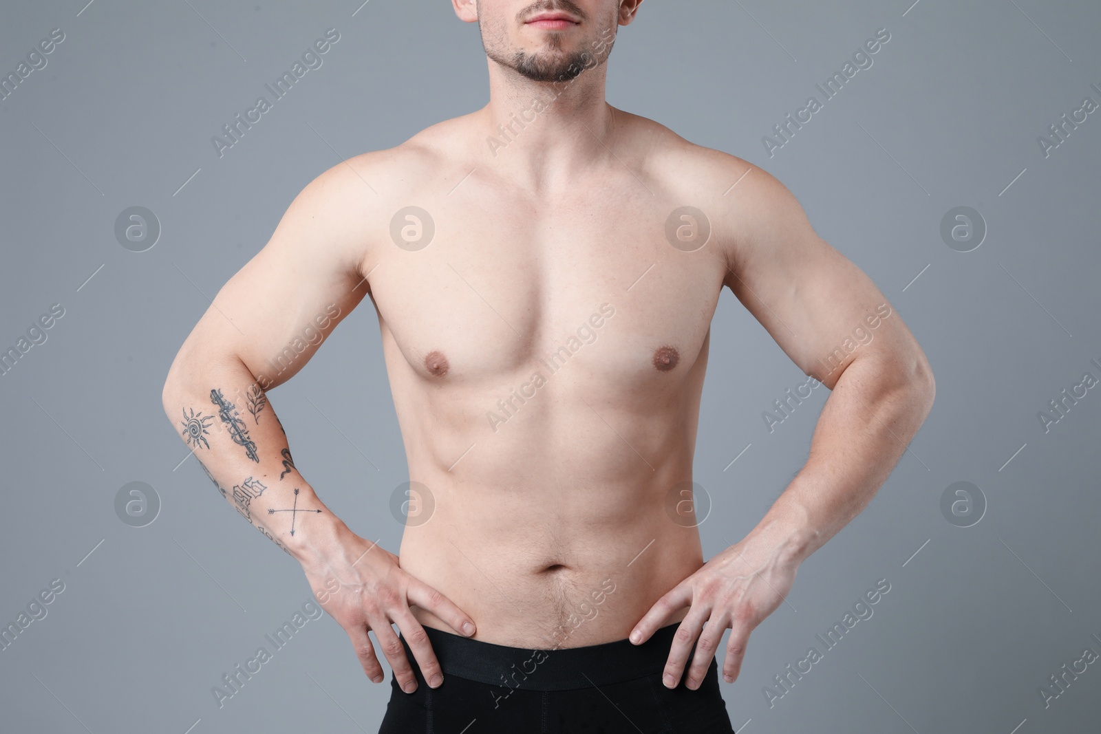 Young man with smooth chest after epilation procedure on light grey background, closeup Photo of Young man with smooth chest after epilation procedure on light grey background, closeup