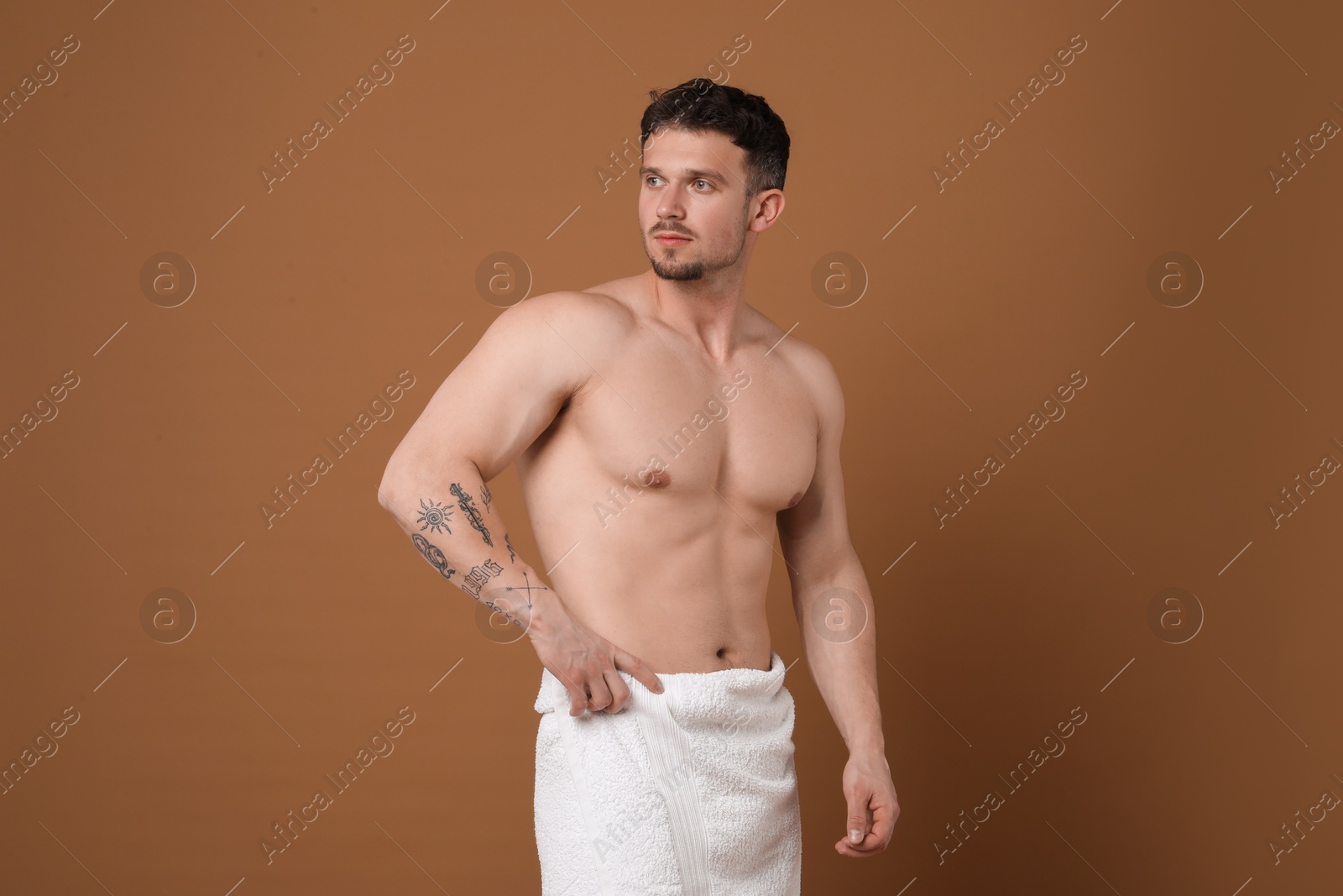 Young man with smooth chest after epilation procedure on brown background Photo of Young man with smooth chest after epilation procedure on brown background
