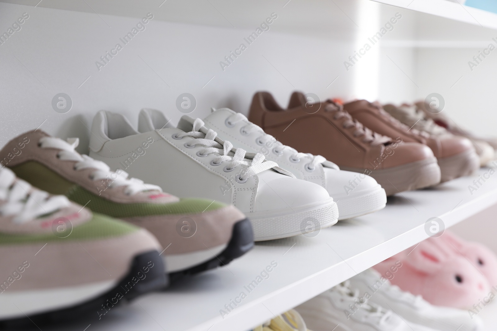 Different footwear on shelf indoors, closeup. Shoe storage Photo of Different footwear on shelf indoors, closeup. Shoe storage