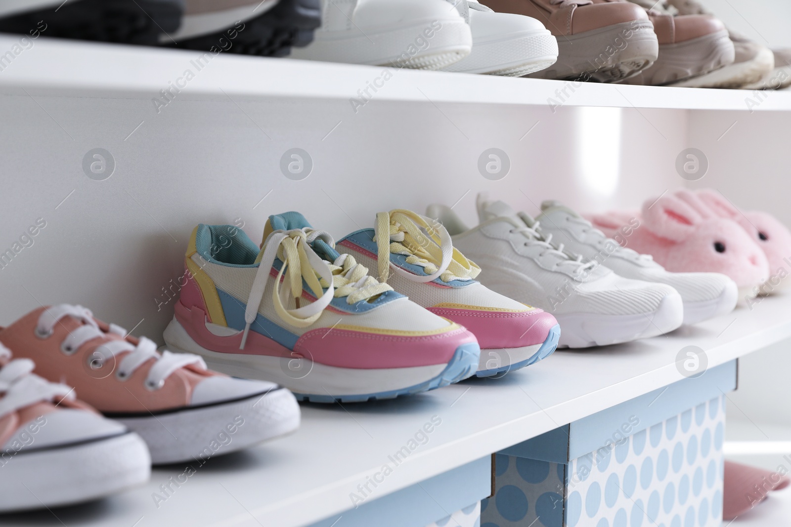 Different footwear on shelves indoors, closeup. Shoe storage Photo of Different footwear on shelves indoors, closeup. Shoe storage