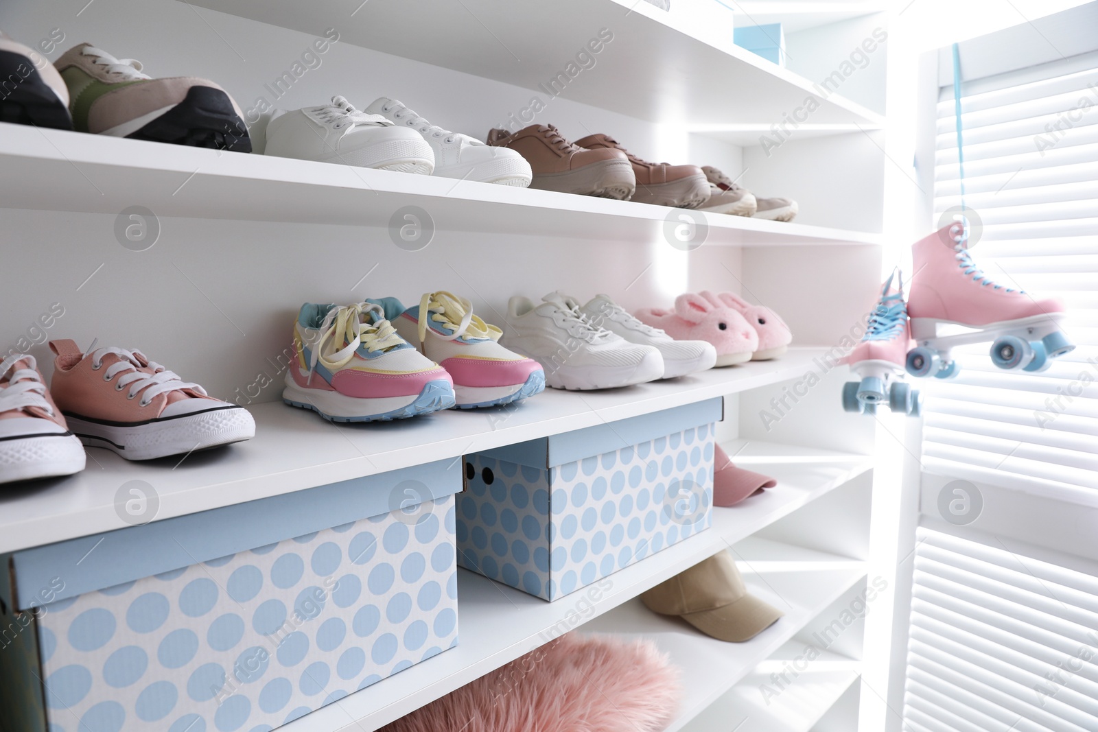 Different footwear and accessories on shelves indoors, closeup. Shoe storage Photo of Different footwear and accessories on shelves indoors, closeup. Shoe storage