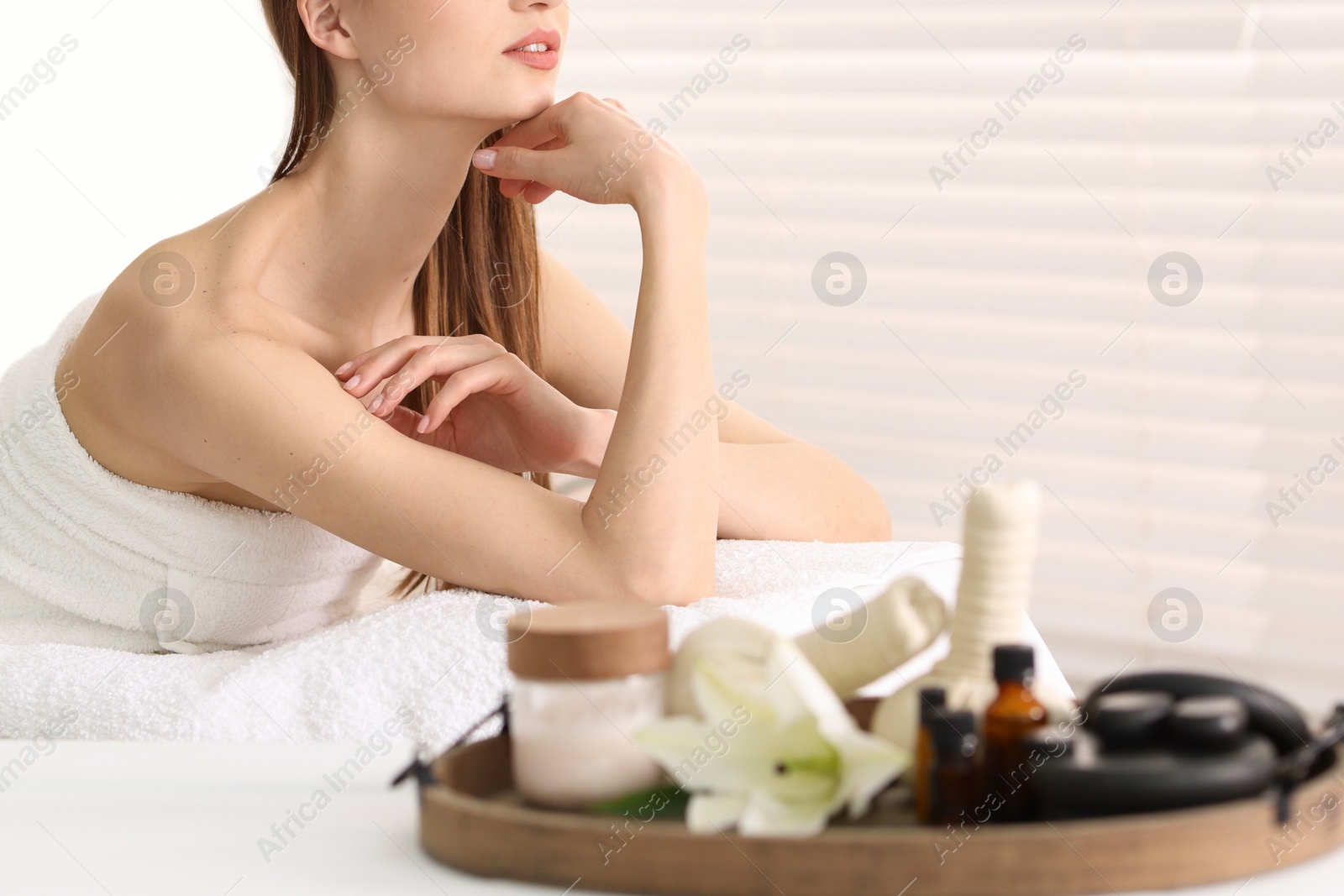 Beautiful woman relaxing on massage couch in spa salon, selective focus Photo of Beautiful woman relaxing on massage couch in spa salon, selective focus