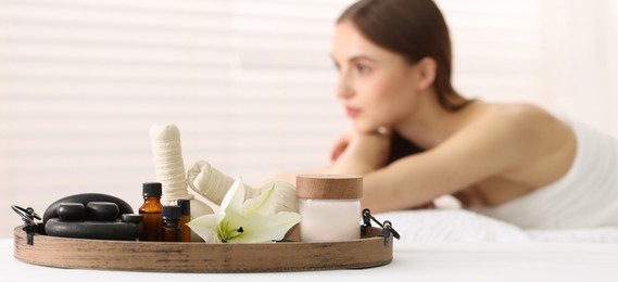 Photo of Beautiful woman relaxing on massage couch in spa salon, selective focus