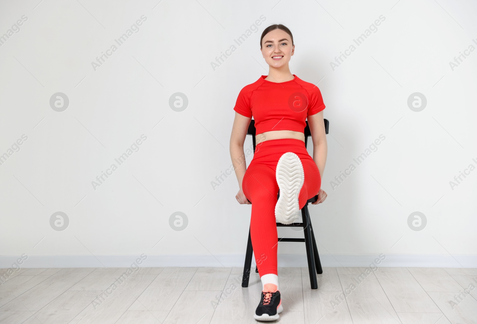 Beautiful woman stretching on chair at home, space for text Photo of Beautiful woman stretching on chair at home, space for text