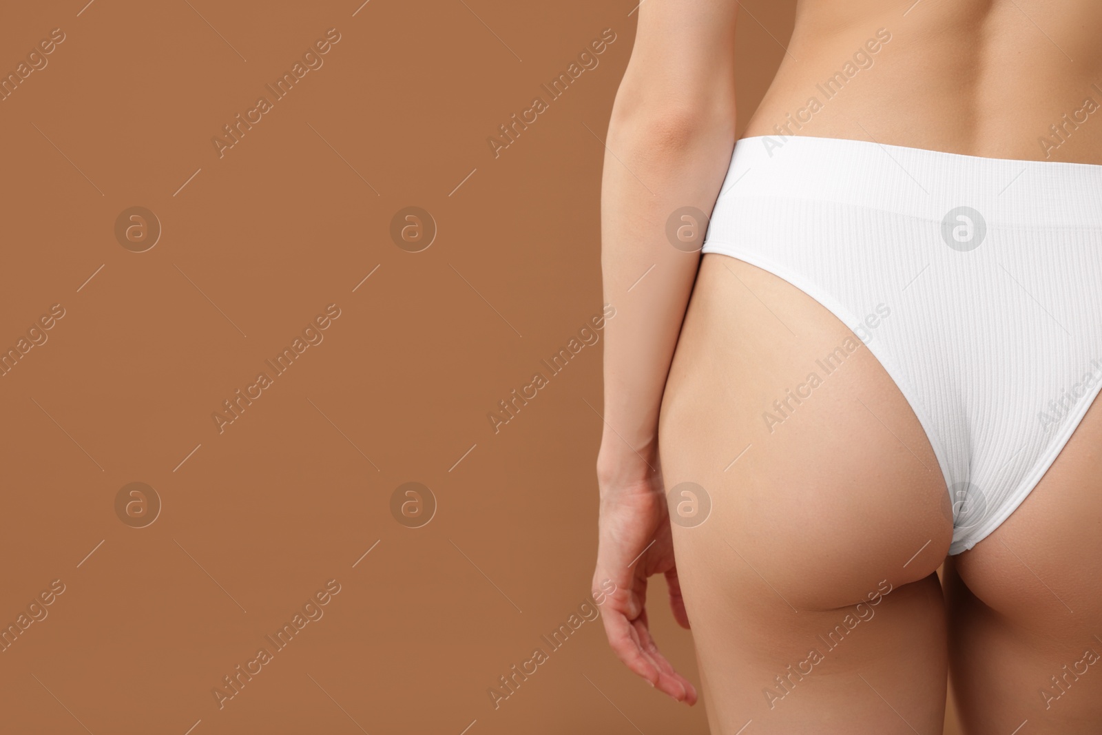 Woman with perfect slim body on beige background, closeup. Space for text Photo of Woman with perfect slim body on beige background, closeup. Space for text