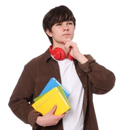 Photo of Teenage boy with headphones and notebooks on white background