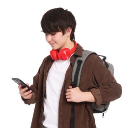 Photo of Teenage boy with backpack, headphones and smartphone on white background
