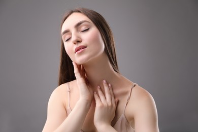 Photo of Portrait of beautiful woman on grey background