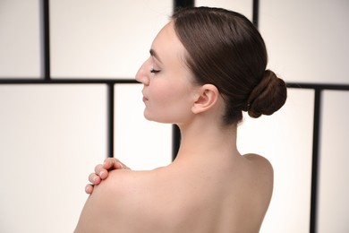 Photo of Beautiful woman on light background, back view
