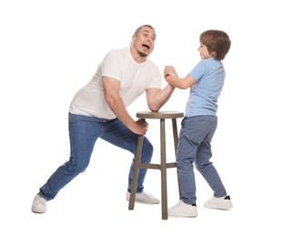 Photo of Father with his son arm wrestling on white background