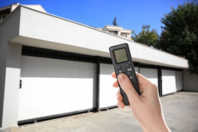 Image of Woman using remote to control garage door outdoors, closeup